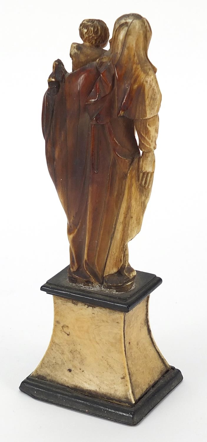 Antique ivory carving of Madonna and child raised on an ebonised and ivory base, 14cm high - Image 3 of 4