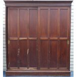 Stained wood hall robe wardrobe with sliding doors and brass handles, 211cm H x 186cm W x 38cm D