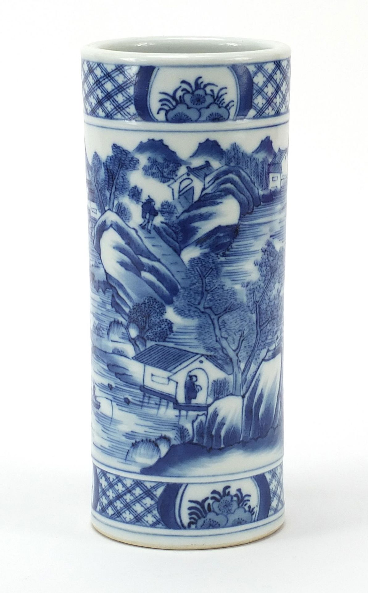 Chinese blue and white brush pot hand painted with a mountainous scene with buildings and figures,