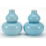 Pair of Chinese porcelain double gourd vases having blue glazes and character marks to the bases,