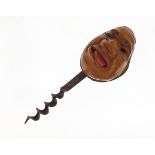 Coquilla nut corkscrew carved with a face, 11cm in length