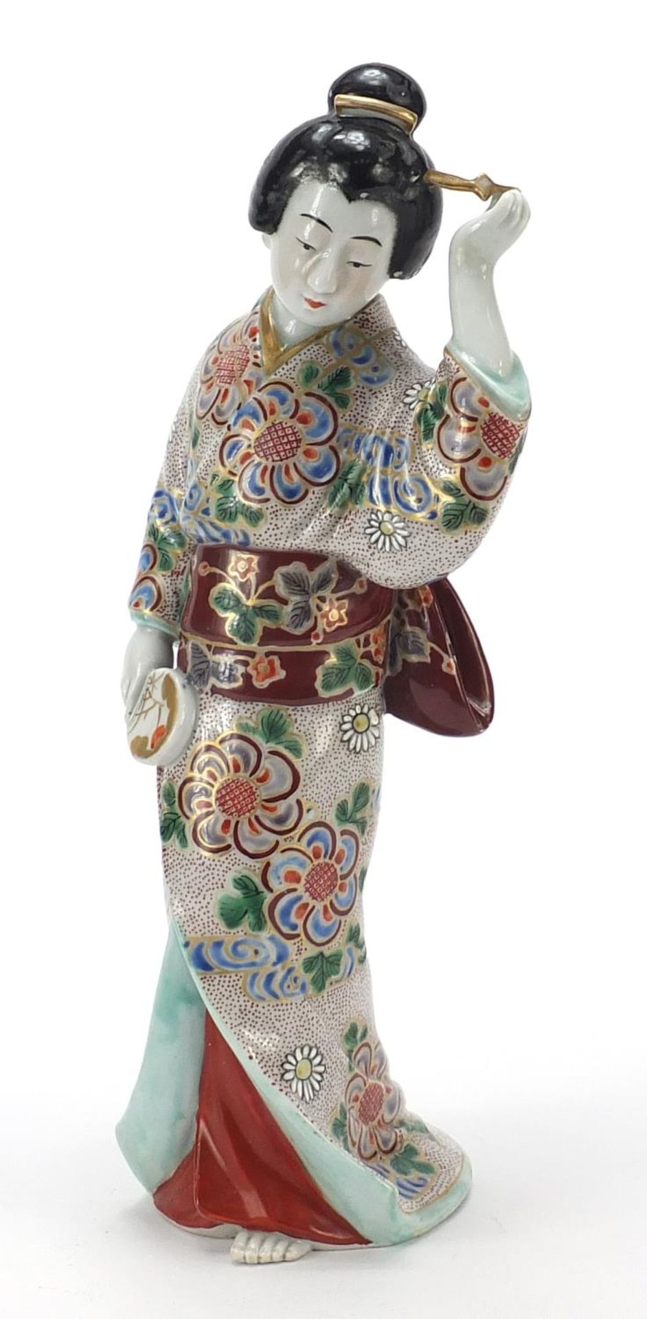 Japanese porcelain figure of a Geisha girl playing with her hair, 32cm high