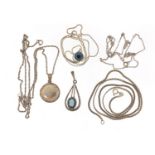Silver jewellery comprising four necklaces and three pendants including a locket, 21.5g