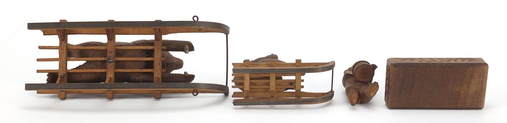 Three carved Black Forest bears and a matchbox including two riding sleds, the largest 15cm in - Image 5 of 5