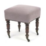 Mahogany footstool with turned legs, brass casters and purple upholstery, 47cm H x 43cm W x 43cm D