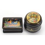 Two Russian black lacquered trinket boxes including one in the form of a barrel hand painted with