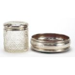 Circular silver and oak wine coaster and a cut glass jar with silver lid embossed with Putti,
