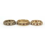 Three 9ct gold eternity rings set with sapphires, clear stones and garnets, sizes N, P and R, 8.8g