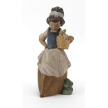 Lladro pottery model of a young girl carrying a basket, with two ducks, 24.5cm