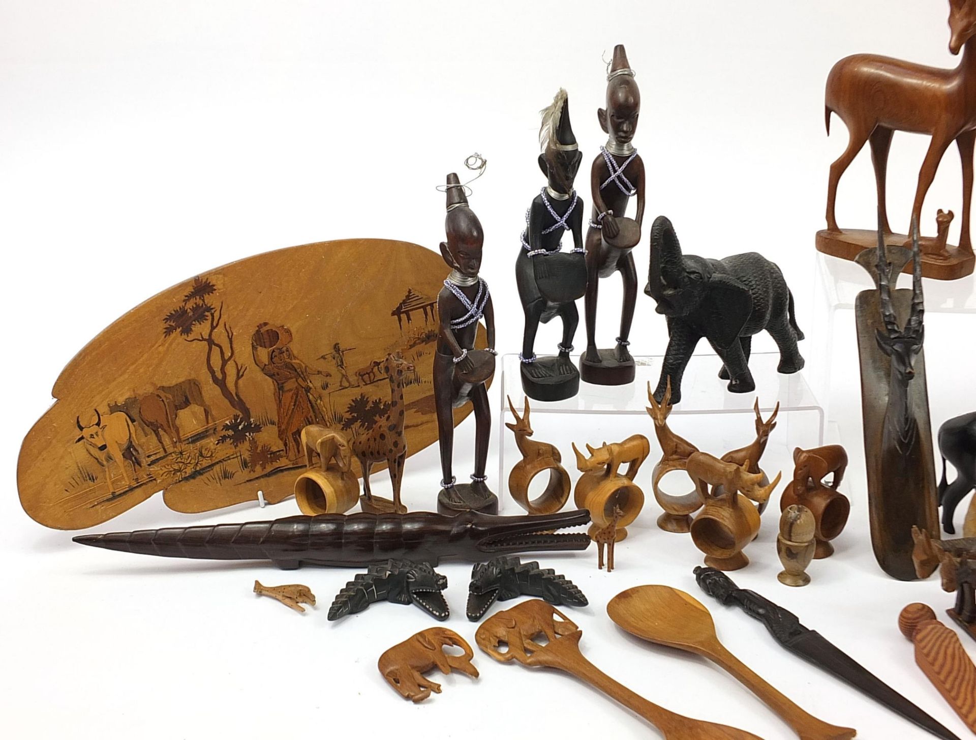 African woodenware to include carved elephants, table lamp, wall plaque, figures and a carving - Image 2 of 7