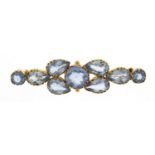 Unmarked gold blue stone brooch, (tests as 9ct gold) 5cm wide, 5.6g