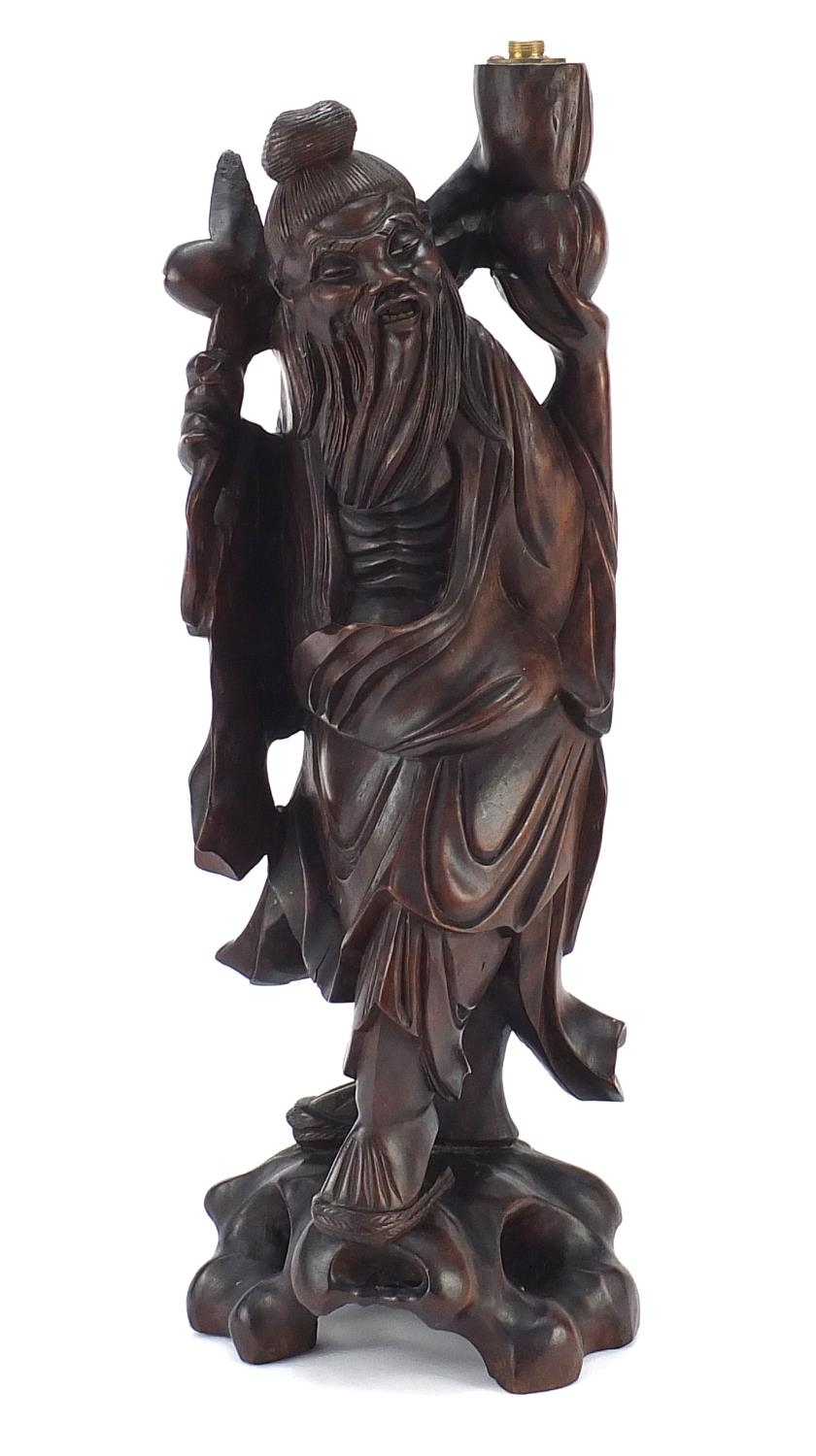 Chinese hardwood lamp carved in the form of an elder, 43.5cm high