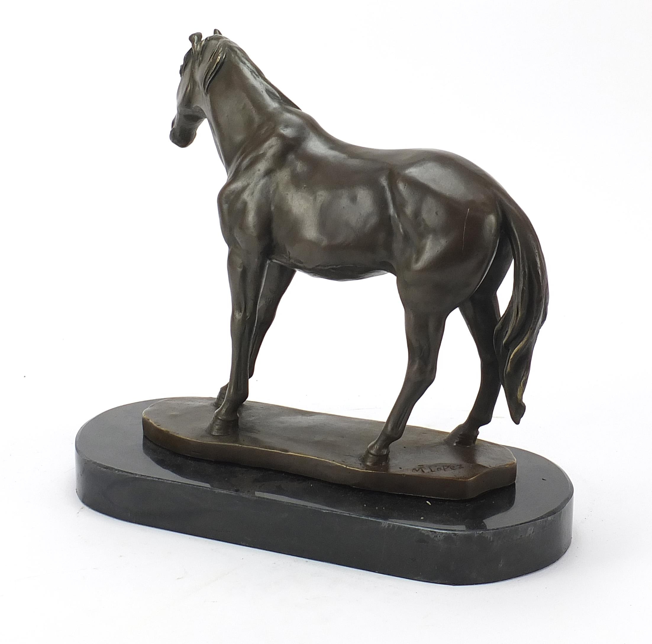 Patinated bronze horse raised on a black slate base, 33cm in length - Image 2 of 4