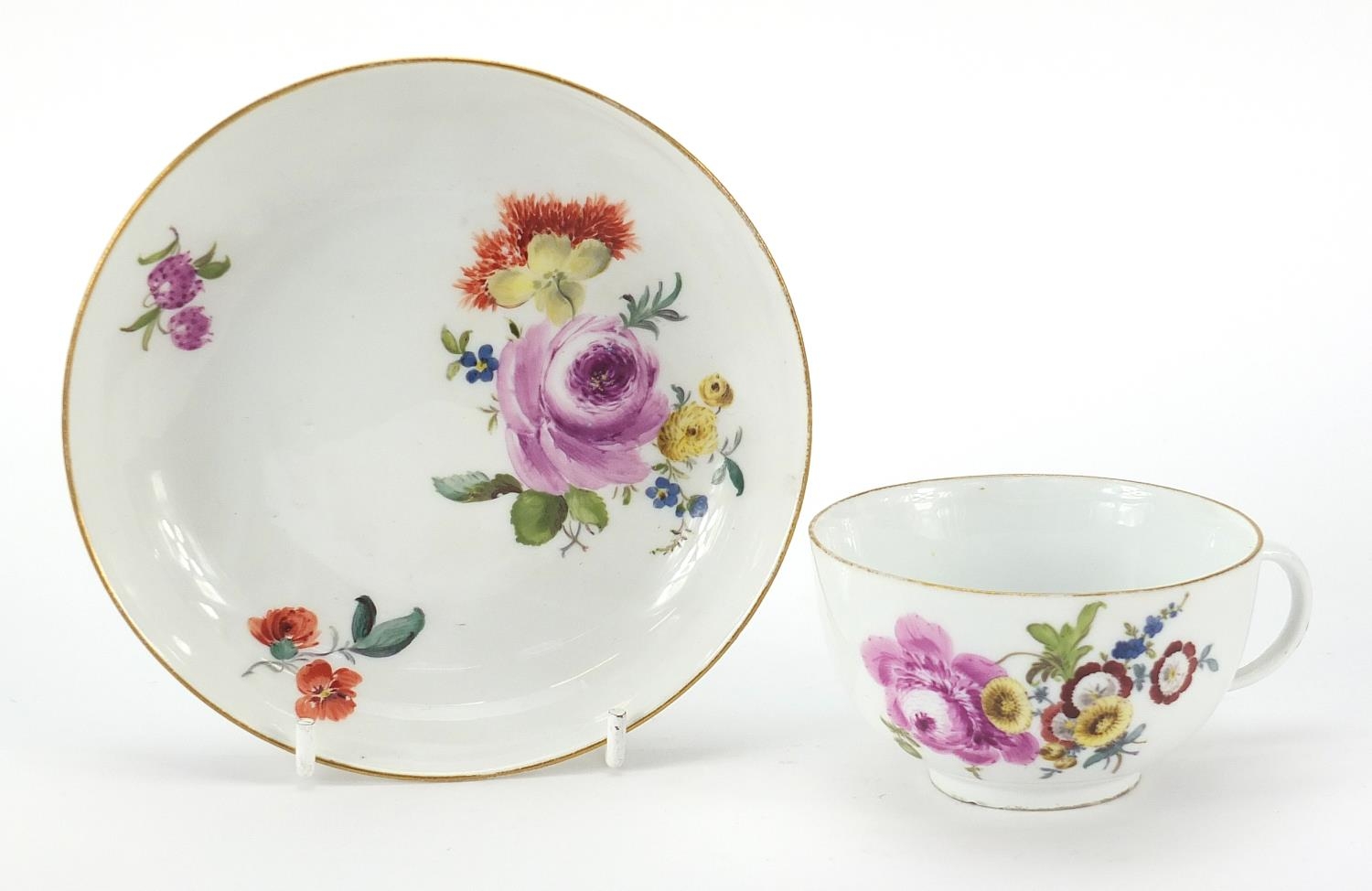 Meissen, 19th century porcelain cup and saucer hand painted with flowers, the saucer 13.5cm in