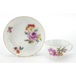 Meissen, 19th century porcelain cup and saucer hand painted with flowers, the saucer 13.5cm in