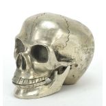Silvered model of a human skull with hinged jaw, 10cm high