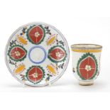 Turkish Kutahya pottery cup and saucer hand painted with flowers, the largest 13.5cm in diameter
