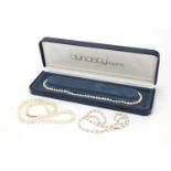 Three cultured pearl necklaces with 9ct gold clasps, the largest 44cm in length, total 51.5g