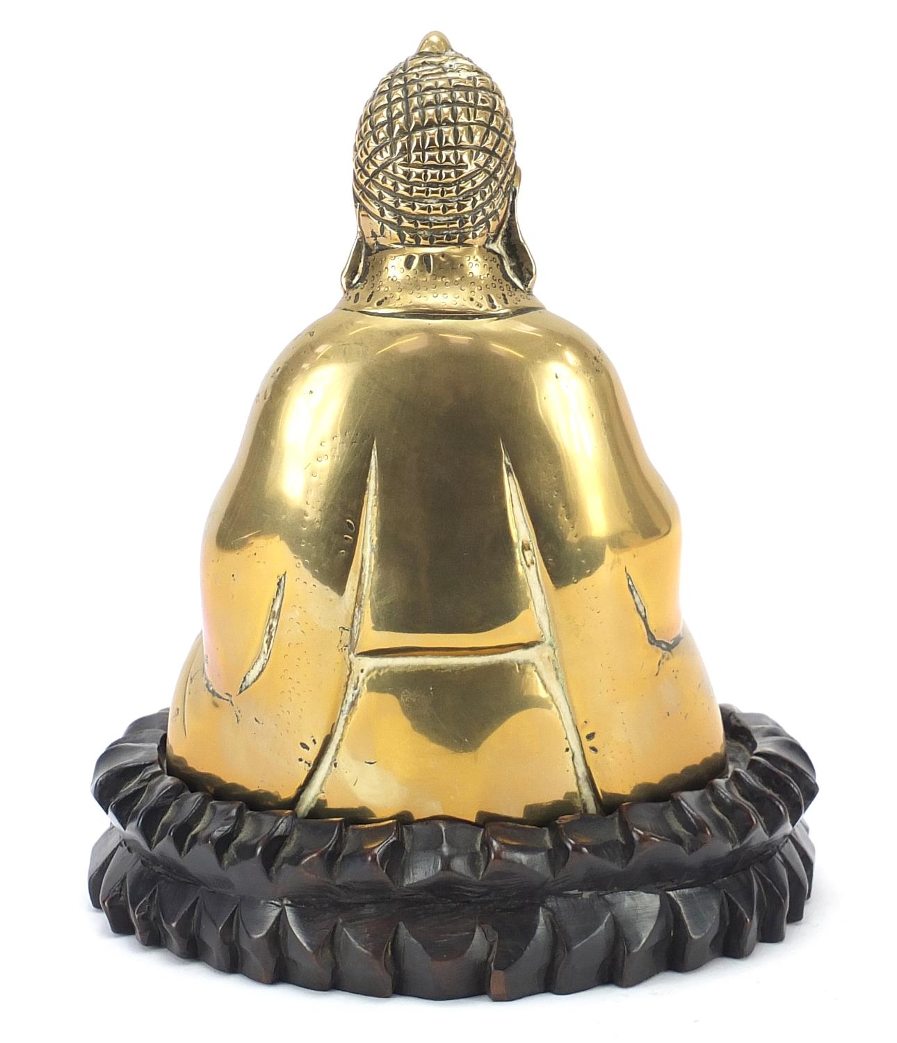 Chinese bronzed figure of Buddha raised on a carved hardwood lotus stand, 23.5cm high - Image 4 of 7