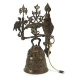 Bronzed swinging arm doorbell with a griffin and a cord lanyard, 35cm high