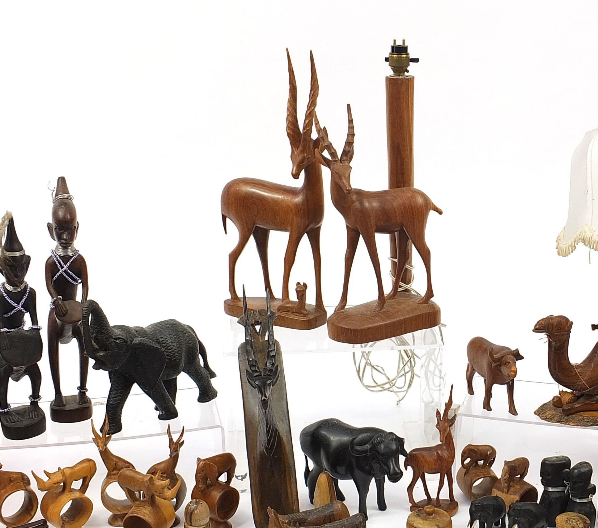 African woodenware to include carved elephants, table lamp, wall plaque, figures and a carving - Image 3 of 7