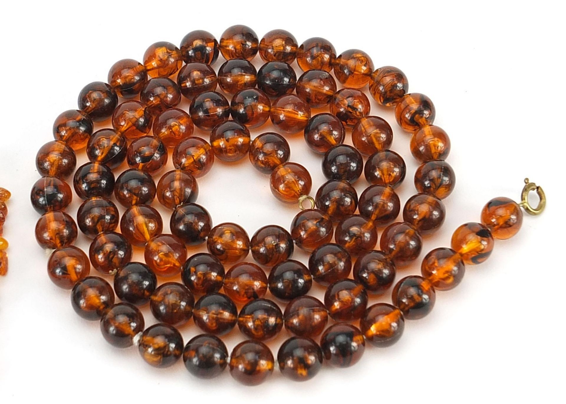 Two amber coloured necklaces and a nut necklace, the largest 80cm in length, total 142.6g - Image 4 of 4
