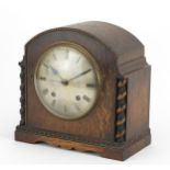 Oak cased striking mantle clock with silvered dial and barley twist columns, 23cm high