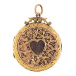 9ct gold back and front circular locket with engraved decoration, 2.8cm in diameter, 5.7g