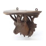 Black Forest carved wall bracket in the form of a goat's head, 11cm high