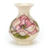 Moorcroft pottery vase decorated with flowers in the Magnolia pattern, 13cm high