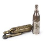 Two military interest trench art lighters including one in the form of a bottle, the largest 7.5cm