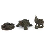 Three Japanese patinated bronze animals comprising tortoise, elephant and water buffalo desk seal,