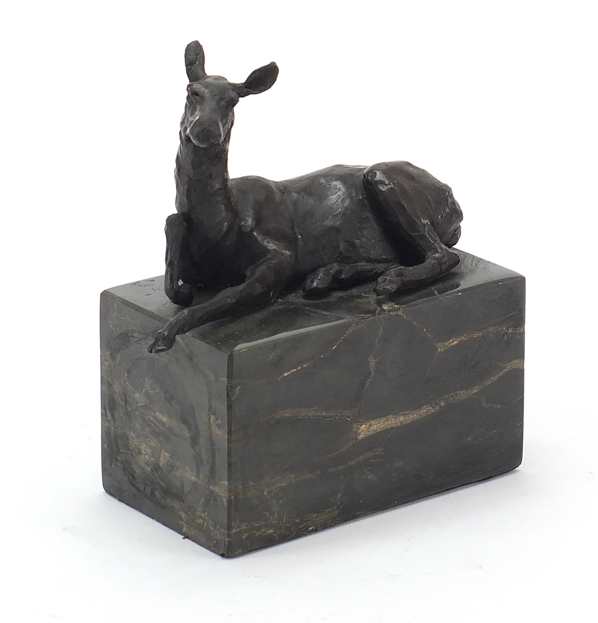 Mid century design patinated bronze sculpture of a recumbent deer raised on a black marble base,