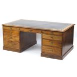 Large oak partner's desk with black leather insert above a series of drawers, reputedly Boris