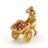 9ct gold and enamel fruit seller with cart charm, 1.5cm high, 3.1g