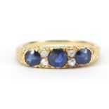 Unmarked gold sapphire and diamond ring, the central sapphire approximately 4mm in diameter, size O,