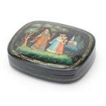 Russian lacquered box and cover with hinged lid hand painted with figures and a church, 12.5cm wide