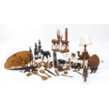 African woodenware to include carved elephants, table lamp, wall plaque, figures and a carving