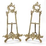 Pair of Rococo style brass easel stands, 38cm high