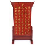 Chinese floor standing red lacquered screen decorated in relief and gilded with calligraphy, 157.5cm