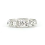 Unmarked white metal graduated diamond five stone ring, the central diamond approximately 4.5mm in