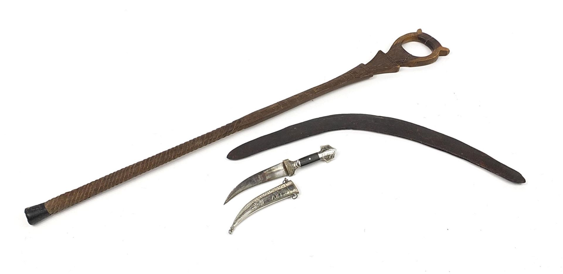 Tribal interest items including an Aboriginal boomerang together with a Middle Eastern dagger, the