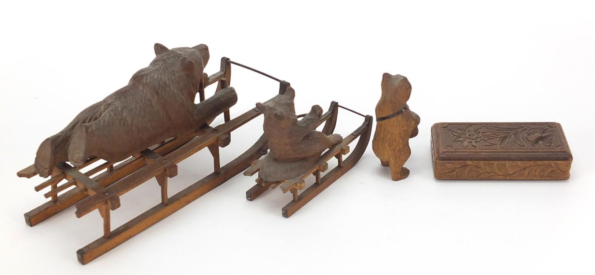 Three carved Black Forest bears and a matchbox including two riding sleds, the largest 15cm in - Image 4 of 5