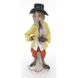 19th century continental porcelain monkey musician, 15cm high