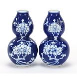 Pair of Chinese blue and white porcelain double gourd prunus vases, character marks to the bases,