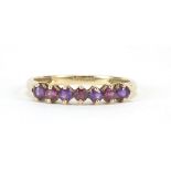 9ct gold garnet and amethyst seven stone ring, size V, 2.0g