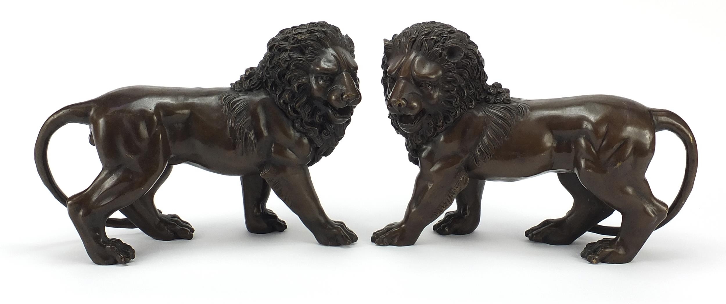 Pair of large patinated bronze standing lions, 30cm in length