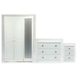 Contemporary white bedroom furniture comprising triple wardrobe, three drawer chest and three drawer