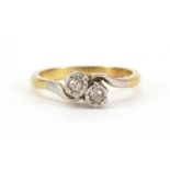 Unmarked gold diamond two stone crossover ring, (tests as 18ct gold) size L, 3.0g