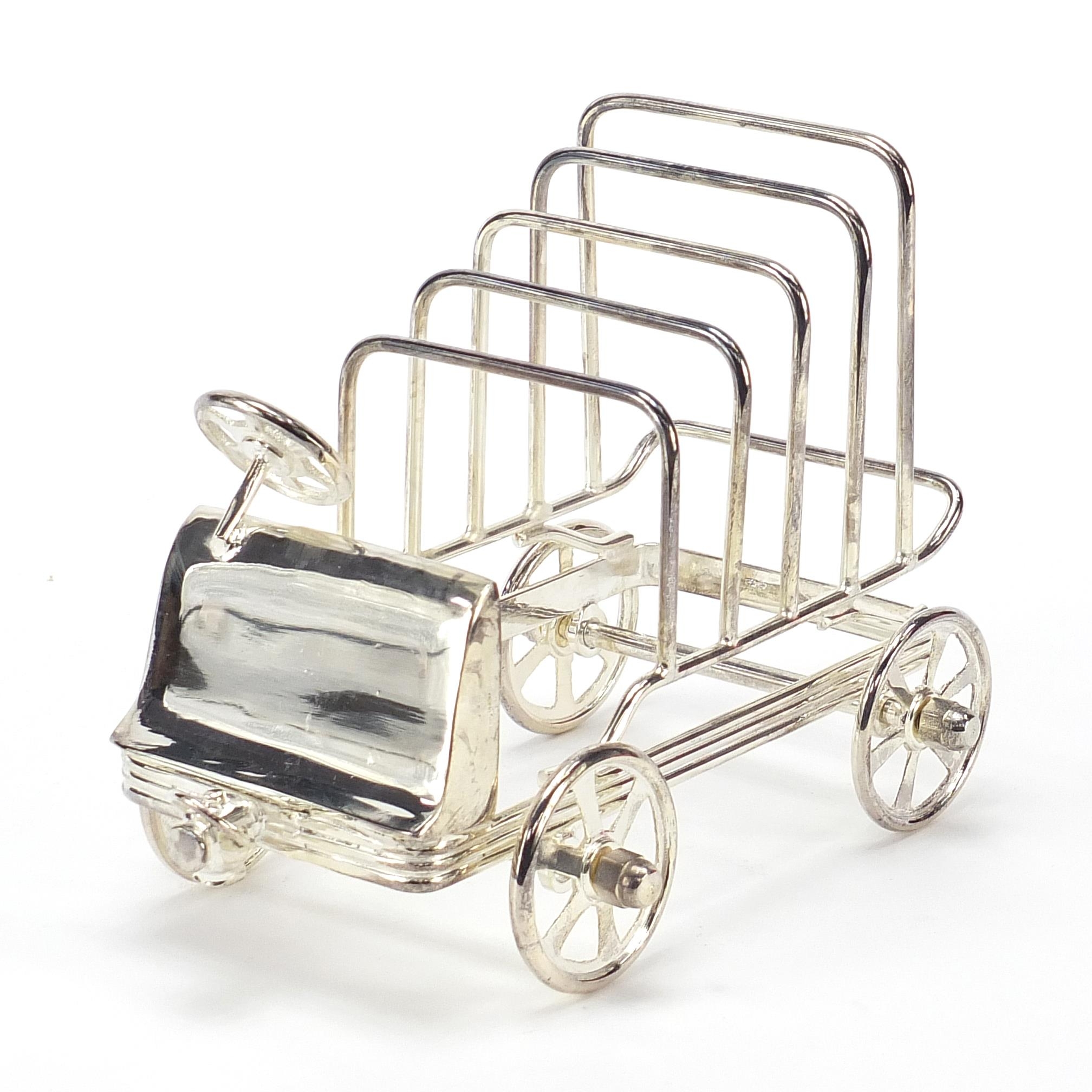 Novelty silver plated five slice toast rack in the form of a car with rotating wheels, 15.5cm in